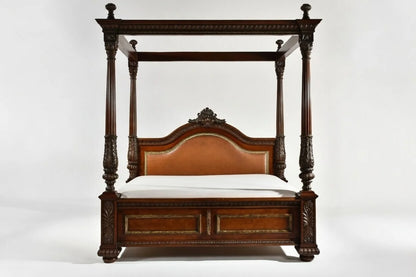 Carved wooden four-poster bed on a white background