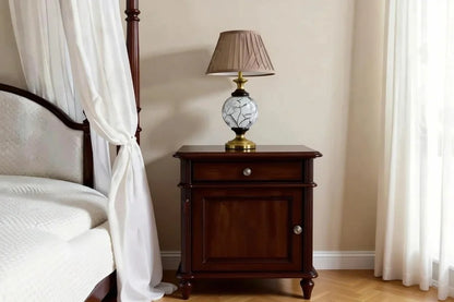 Traditional bedside table in dark walnut finish with one drawer and a cupboard door