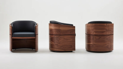 Modern walnut swivel armchair with curved barrel-shaped frame, padded black leather seat and back, sculptural solid walnut construction – front, side, and angled views