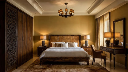 Luxury contemporary teak wood bedroom set featuring carved wardrobe, upholstered king bed, and dressing table