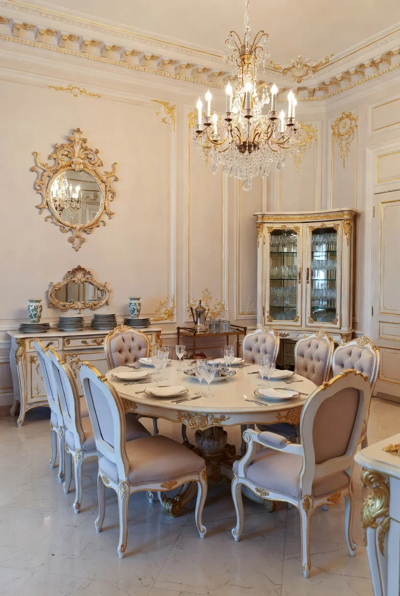 Full luxurious French Baroque dining room in cream white & gold: round Louis XV pedestal table, tufted chairs, vitrine cabinet, console, and crystal chandelier