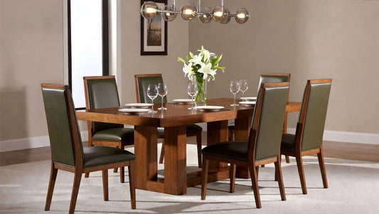 Complete elegant rectangular walnut dining table with architectural trestle base, surrounded by six olive green leather high-back chairs under a glass orb chandelier in a warm, upscale dining space