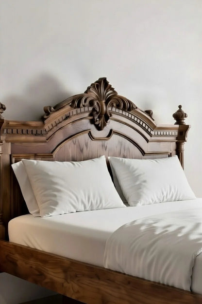 Detailed close-up of hand-carved solid wood headboard on luxury floating bed frame showing craftsmanship and grain texture