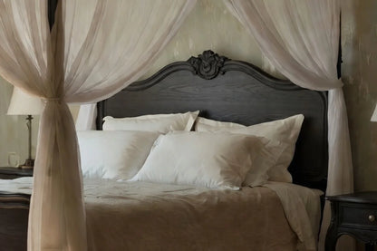 Carved Louis XV style headboard detail on French Provincial four poster canopy bed, ornate solid wood craftsmanship