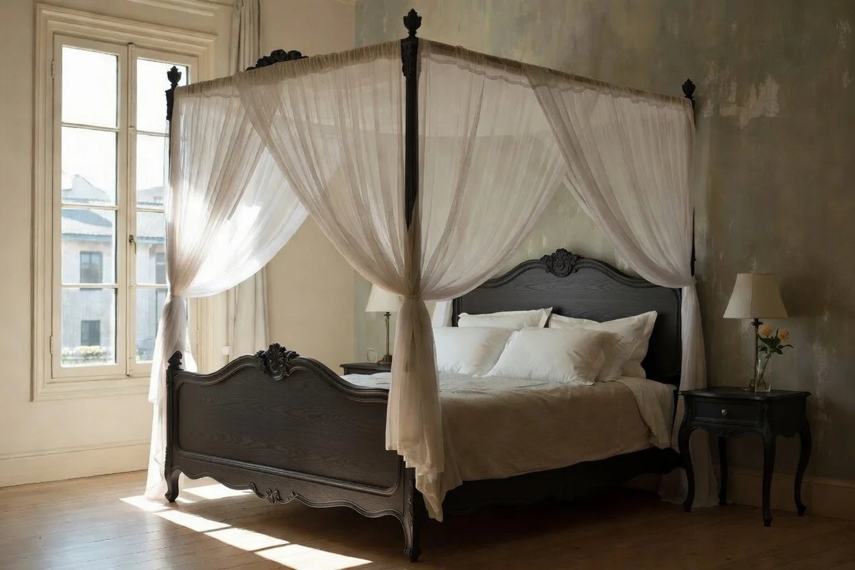Four-poster bed with white canopy and bedding in a room with large windows.