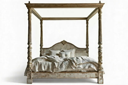 Wooden four-poster bed with bedding on a white background