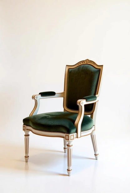 Side view of luxury French Empire chair with emerald velvet upholstery, intricate gold leaf carvings, and classical curved backrest