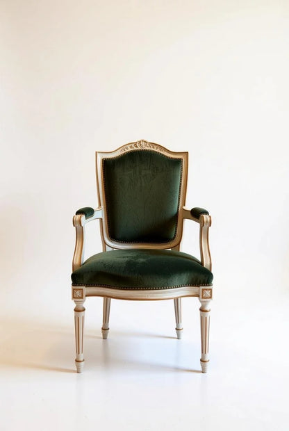 French Empire dining armchair in deep emerald green velvet with ornate hand-carved gold leaf frame, cabriole legs, and regal rococo design