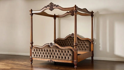 Wooden canopy bed with tufted headboard in a room with beige walls and wooden floor.