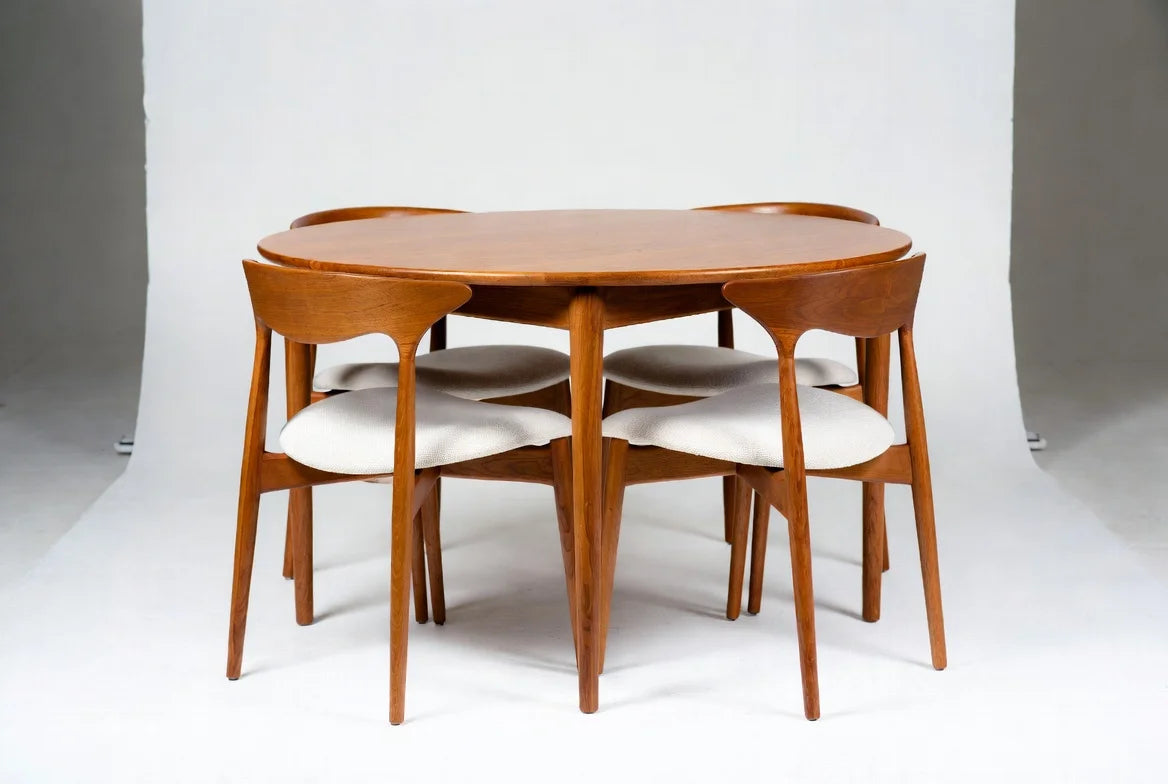 Mid-century modern oval walnut dining table with splayed legs and 4 "Cow Horn" curved back chairs with white upholstered seats, Danish-inspired minimalist set