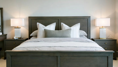 Contemporary dark gray wood king bed with panel headboard and bedside lamps in minimalist style