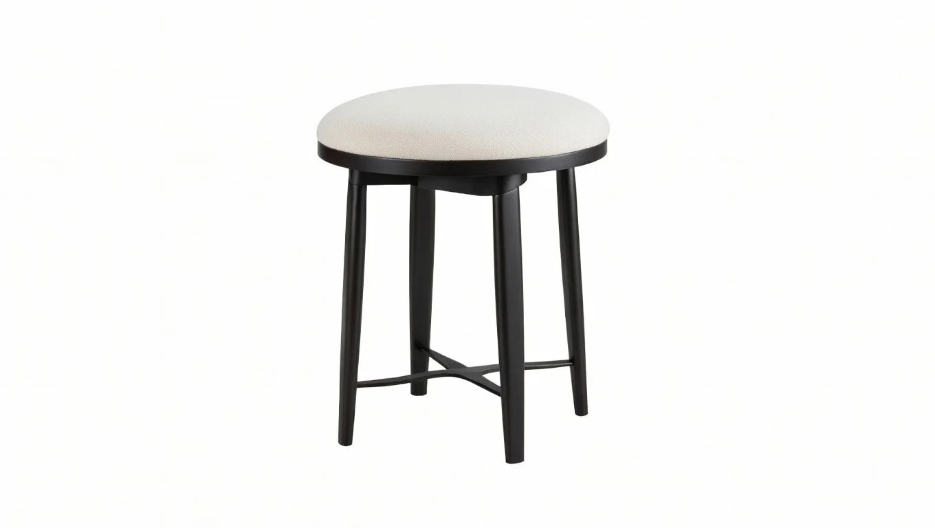 Beige upholstered round stool with black legs from modern gray wood bedroom collection