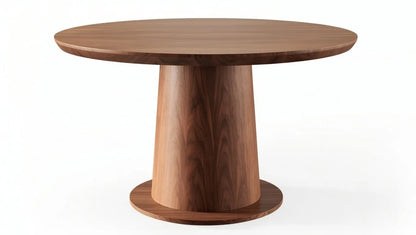 Handcrafted round walnut dining table featuring smooth rounded edge, natural wood grain, and bold tapered cylindrical pedestal base in minimalist design