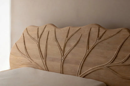 Hand carved solid wood headboard with organic leaf design on contemporary floating platform bed frame