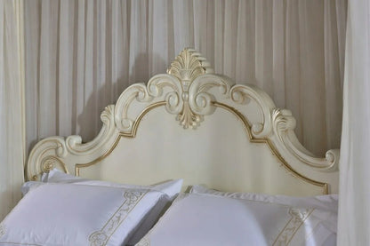 Detailed hand-carving on a solid teak round bed headboard with champagne gold accents and fluted pillars by Makin' It Home.