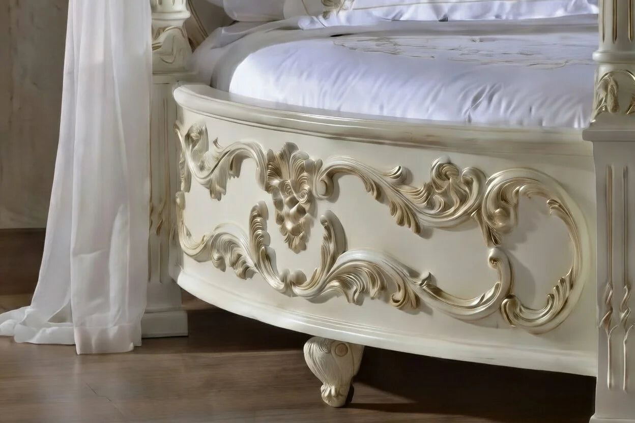 Decorative white bed with intricate carvings in a bedroom setting