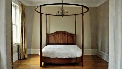 Luxury solid wood canopy bed frame featuring a unique circular top rail and rectangular mattress base.