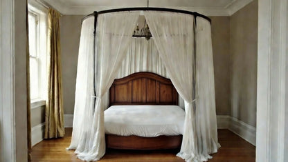 Front view of the Royal Halo canopy bed suite showing the draped curtains and solid wood posts.