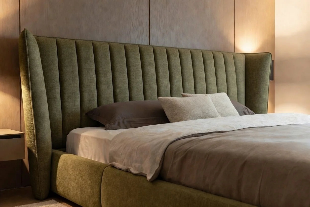 Angled view of solid wood shelter bed highlighting upholstered wingback headboard and low platform design