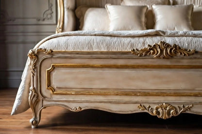 Decorative bed with intricate carvings and white bedding in a room.