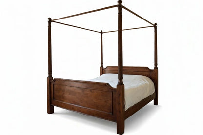 Angled view of luxury wooden four poster canopy bed, handcrafted solid wood traditional canopy bed frame